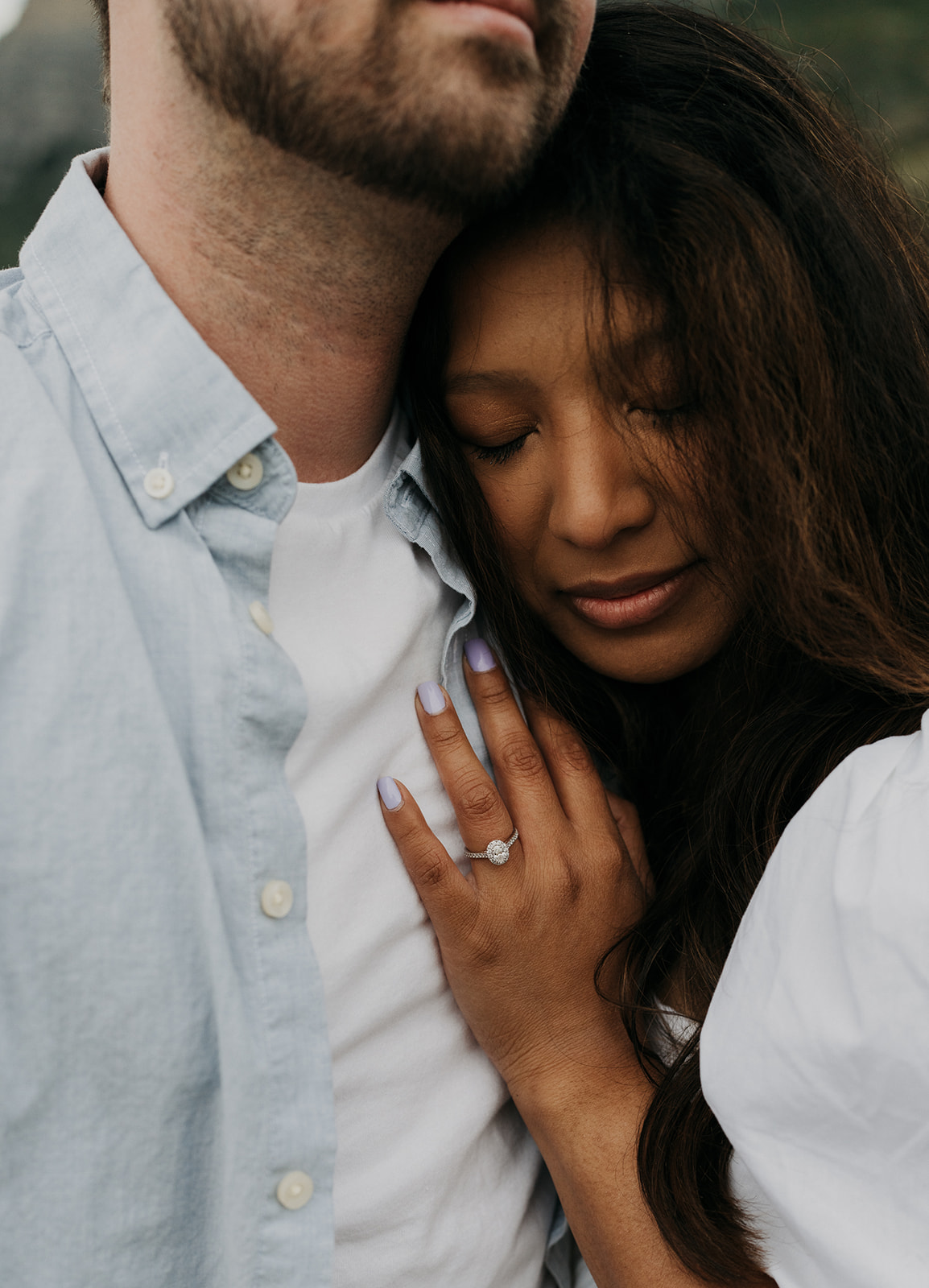 A couple cuddles together showing off her ring with her hand on his chest Staunton State Park Wedding