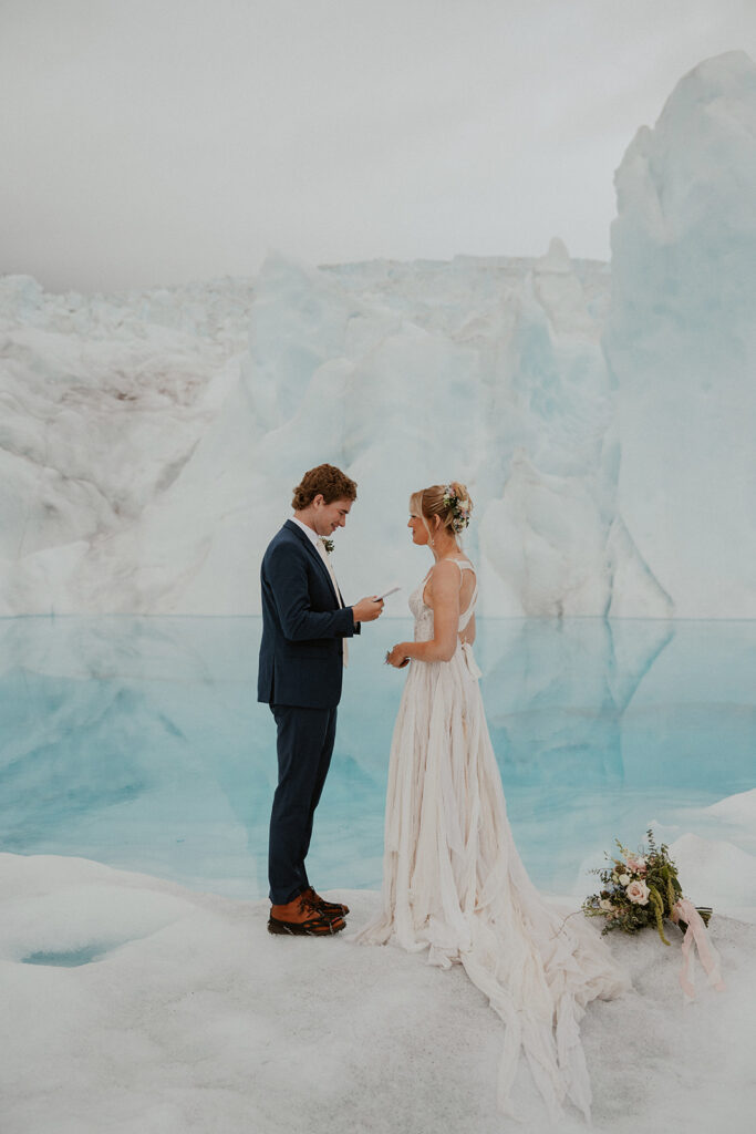 Bride and groom exchanging vows during their Alaska helicopter elopement at Knik Glacier