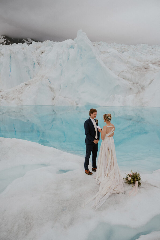 Bride and groom exchanging vows during their Alaska helicopter elopement at Knik Glacier