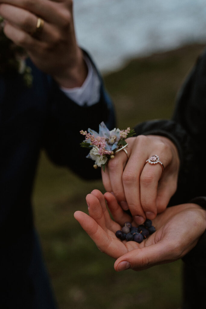 Bride and groom eating wild blueberries at Kniks Glacier after their Alaska helicopter elopement