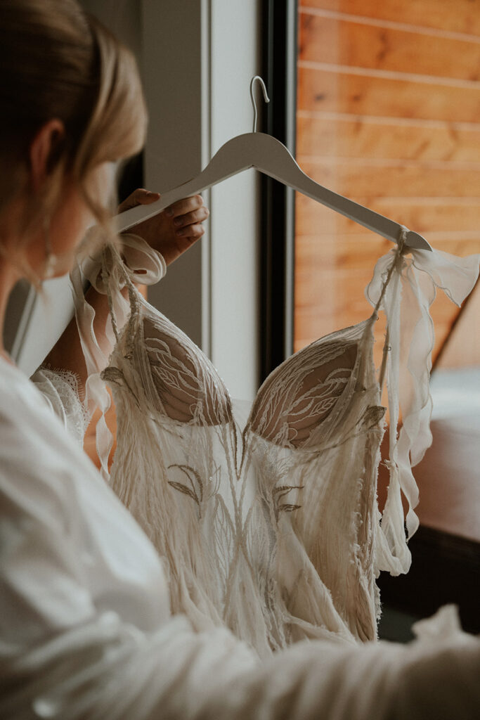 Bride admiring her elopement dress before she puts it on