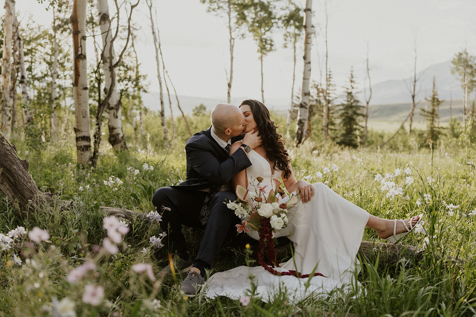 Bride and groom kissing in the mountains during their Breckenridge Colorado elopement photos