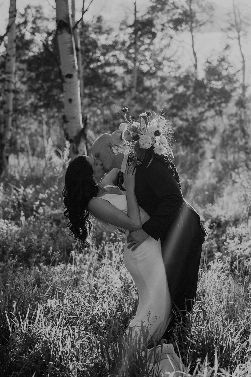 Black and white photo of a bride and groom kissing during their intimate Breckenridge Colorado elopement