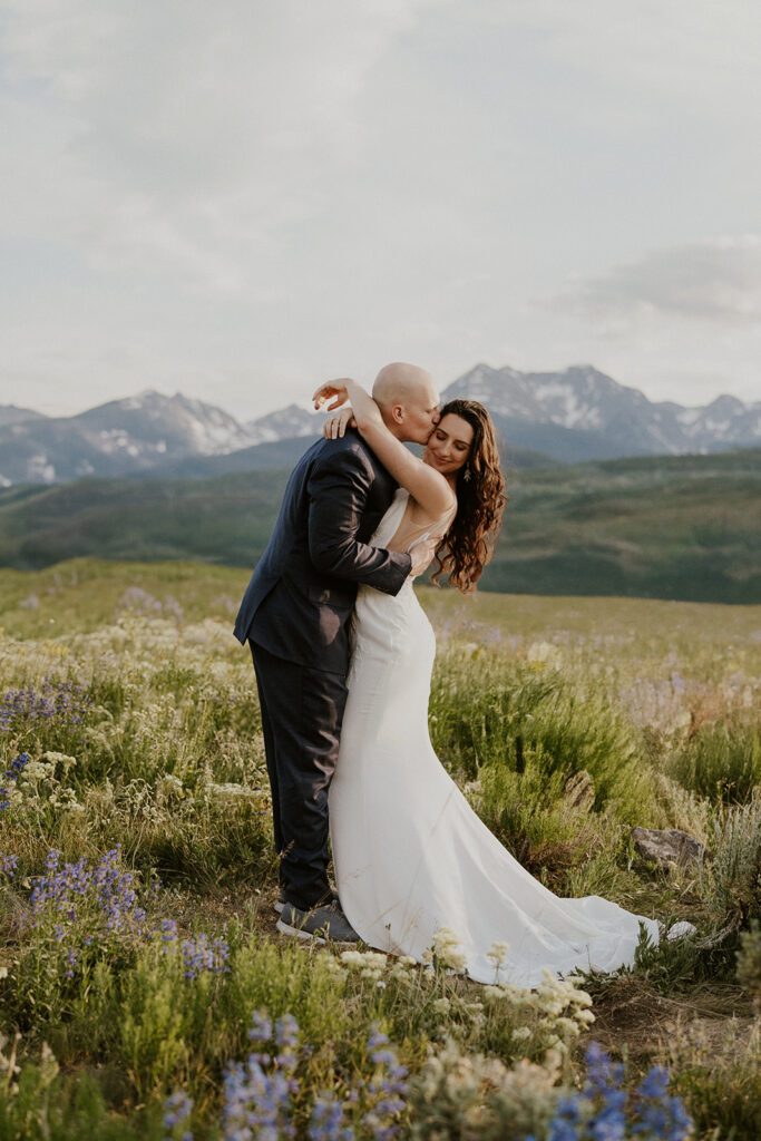 Bride and groom holding onto each other during their intimate Breckenridge Colorado elopement