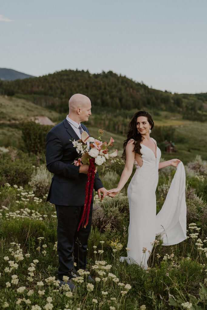 Bride and groom walking through the alpine meadows for their Breckenridge Colorado elopement photos