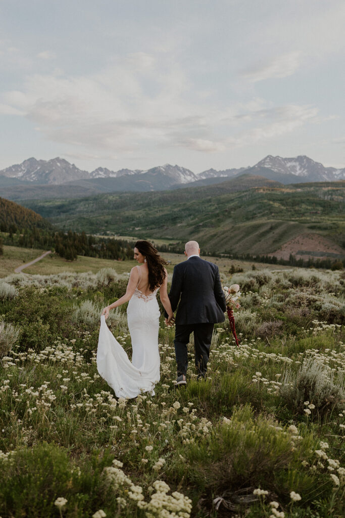 Bride and groom walking through the alpine meadows for their Breckenridge Colorado elopement photos