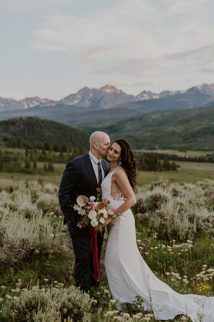Bride and groom sharing kisses in the Colorado mountains