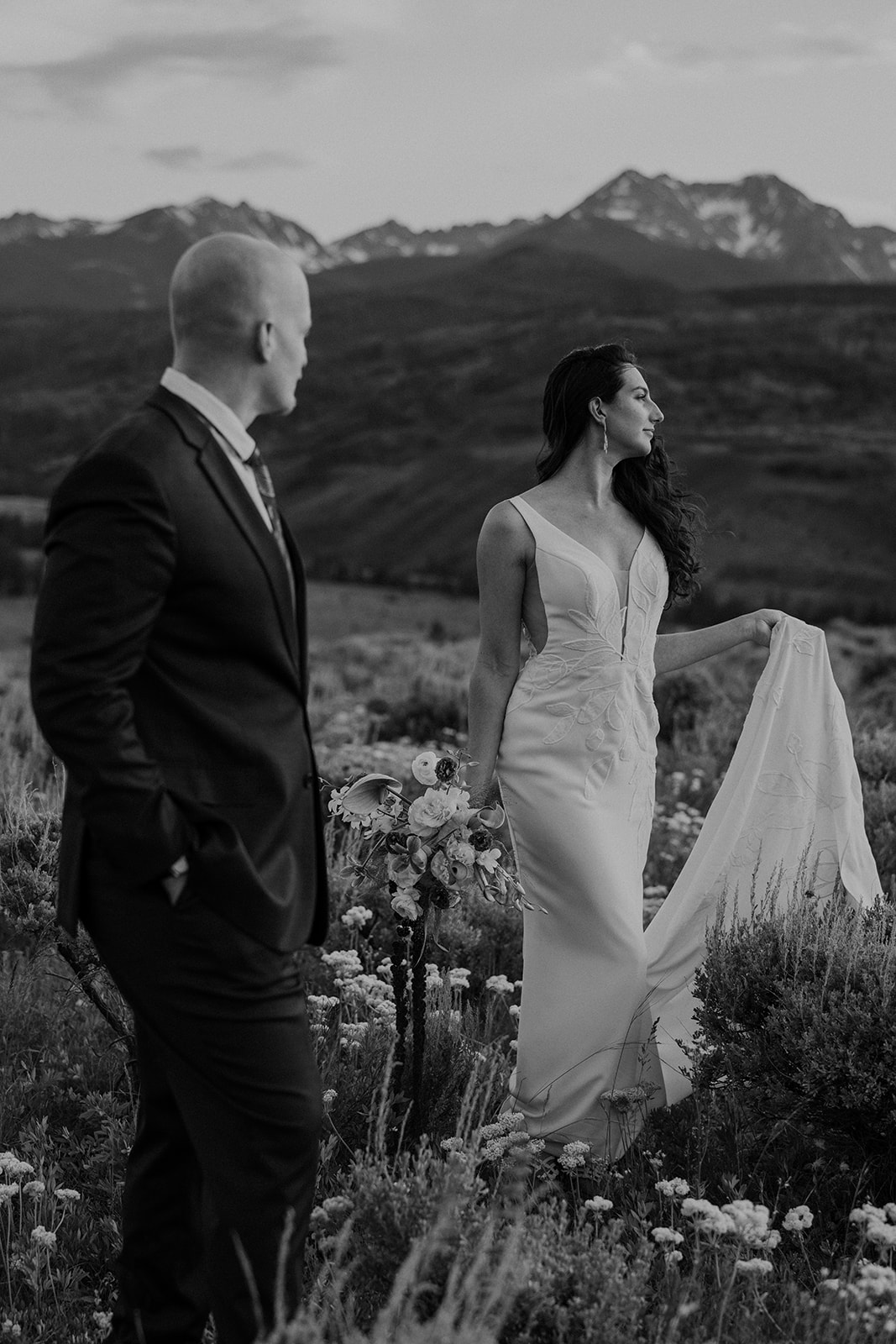 Black and white photo of a bride and groom admiring the mountains in Colorado