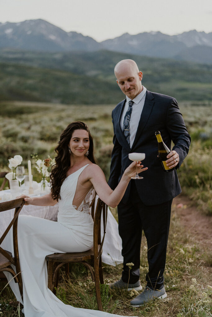 Bride and groom having champagne during their mountain elopement in Breckenridge