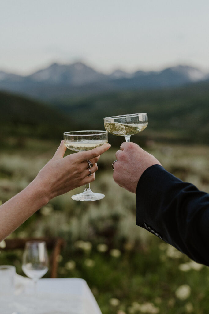 Close up shot of a bride and groom toasting champagne in the mountains of Breckenridge, Colorado