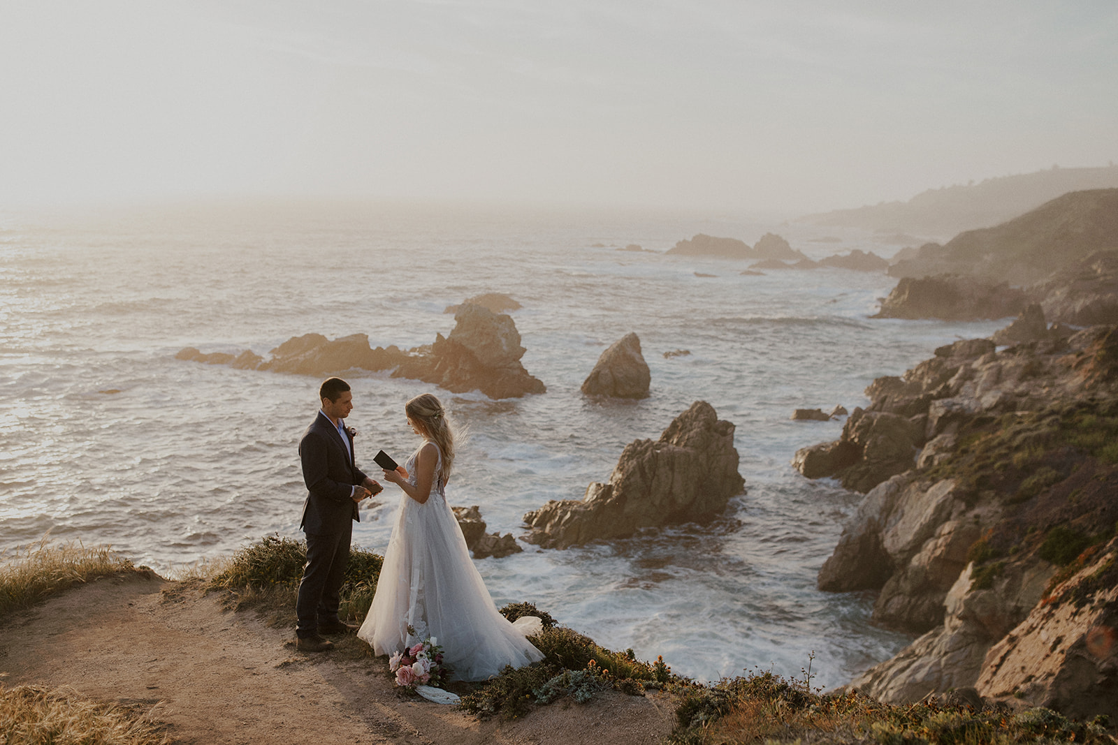 Bride and groom exchanging vows during sunset in Big Sur