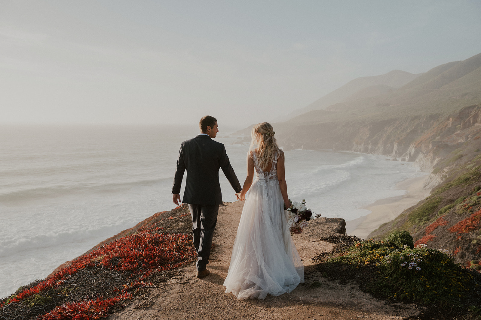Couple standing along the coast for their Big Sur elopement photos
