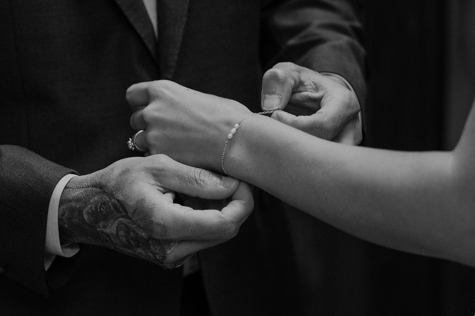 Groom putting the brides bracelet on