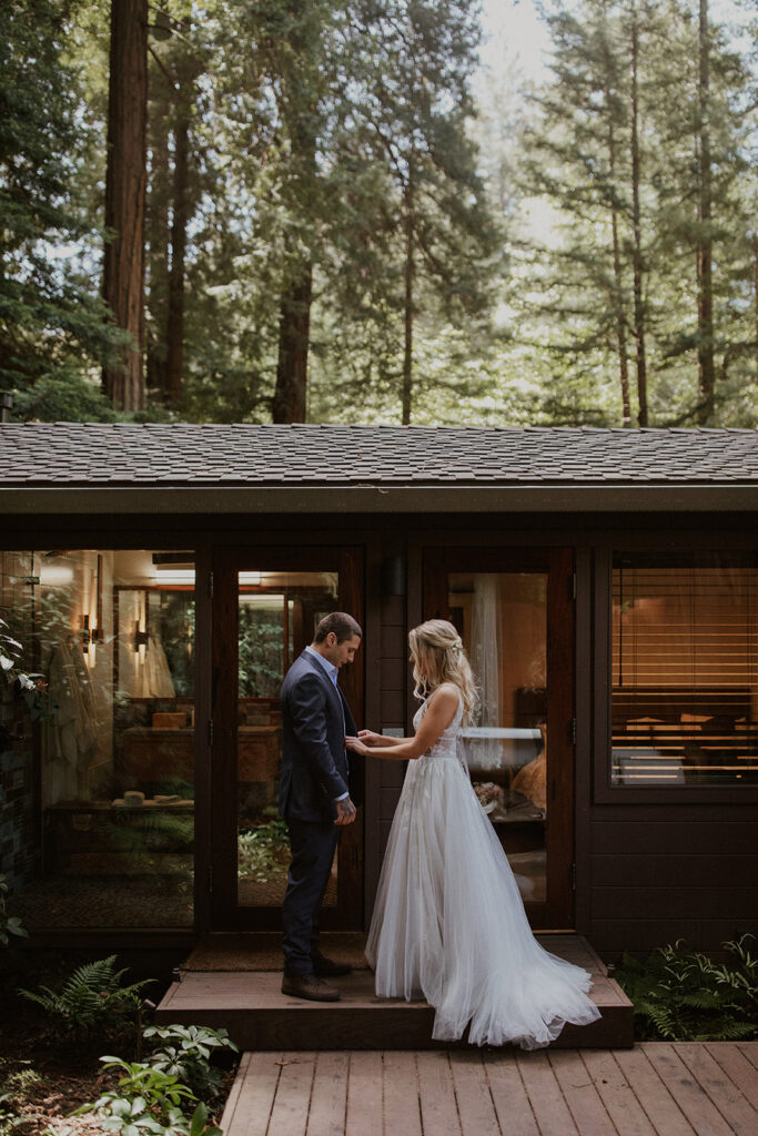 Bride helping the groom get ready for their elopement