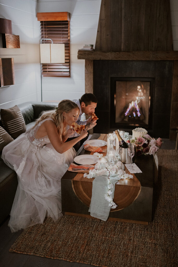 Bride and groom eating pizza during their Big Sur elopement dinner back at Glen Oaks