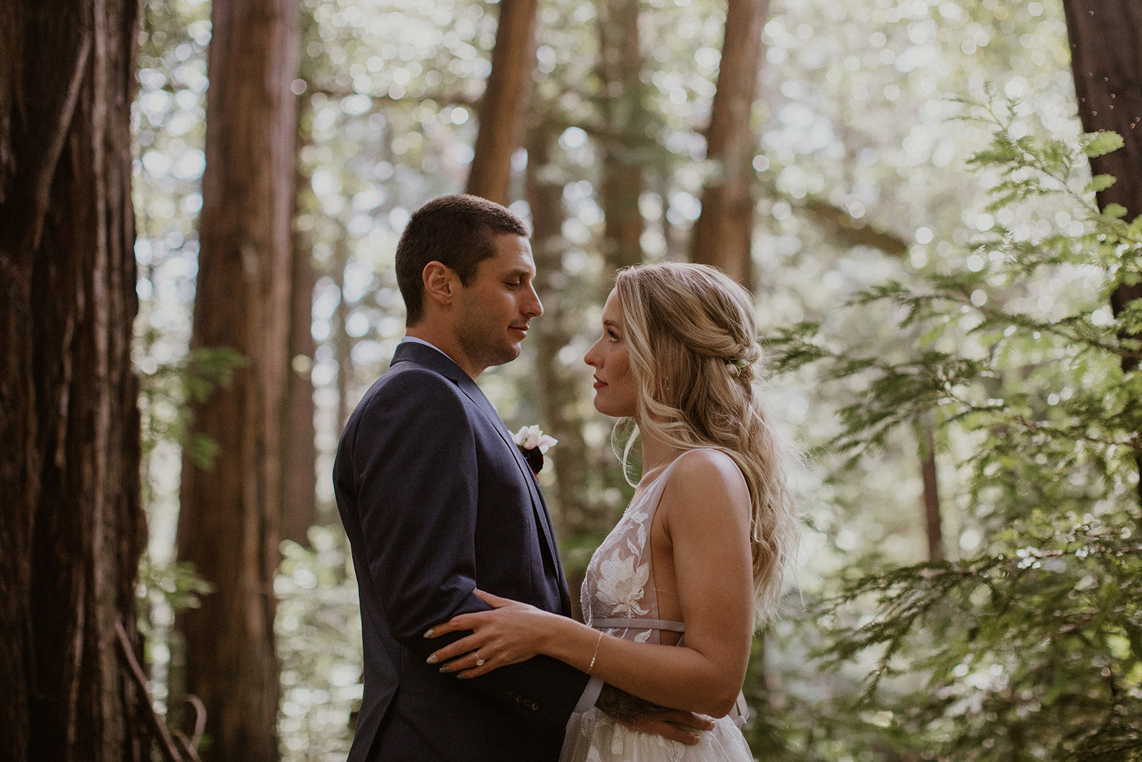 Bride and groom holding each other during their outdoor portraits