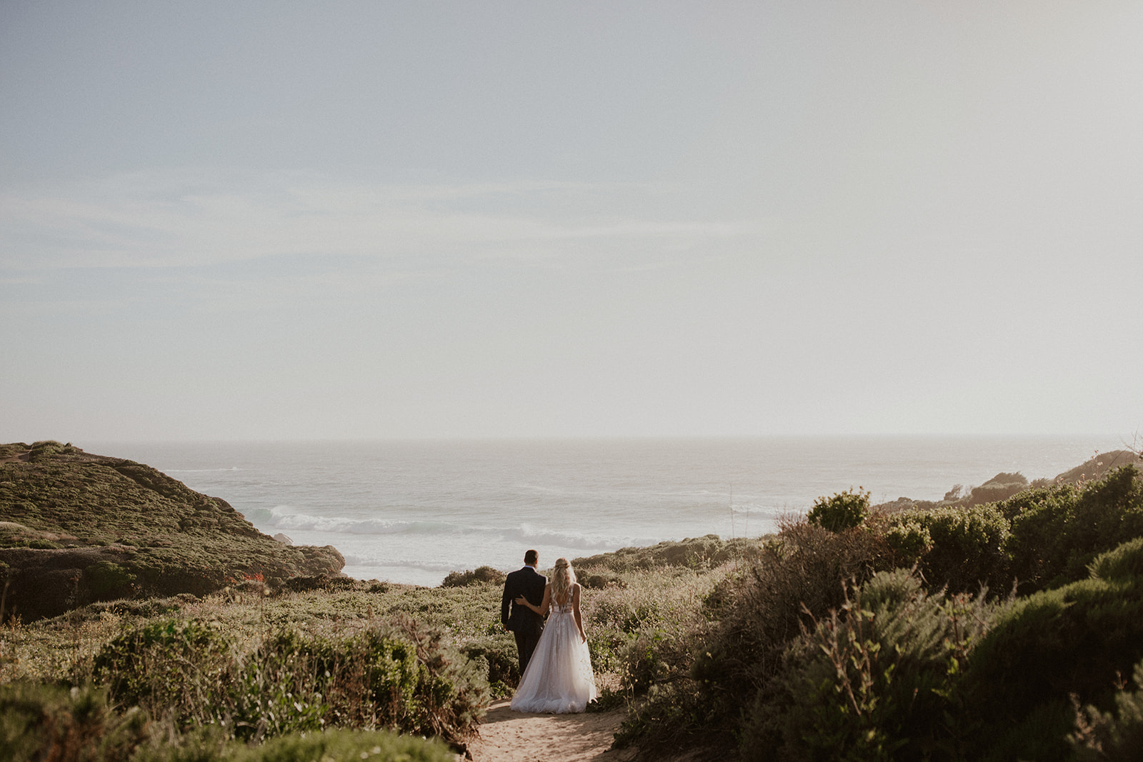 Bride and groom admiring the ocean in Big Sur