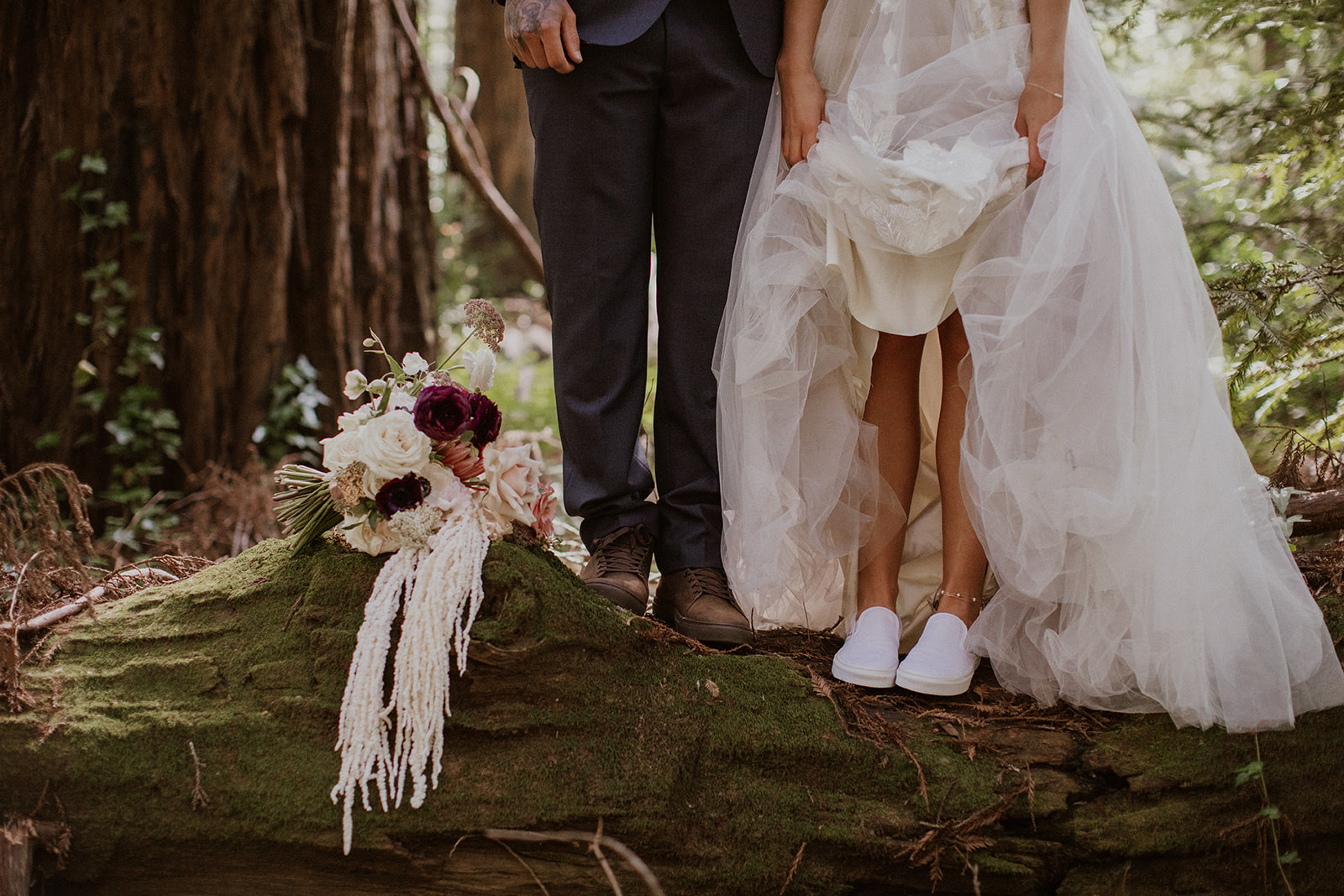 Bride and groom standing on a log in Big Sur, California