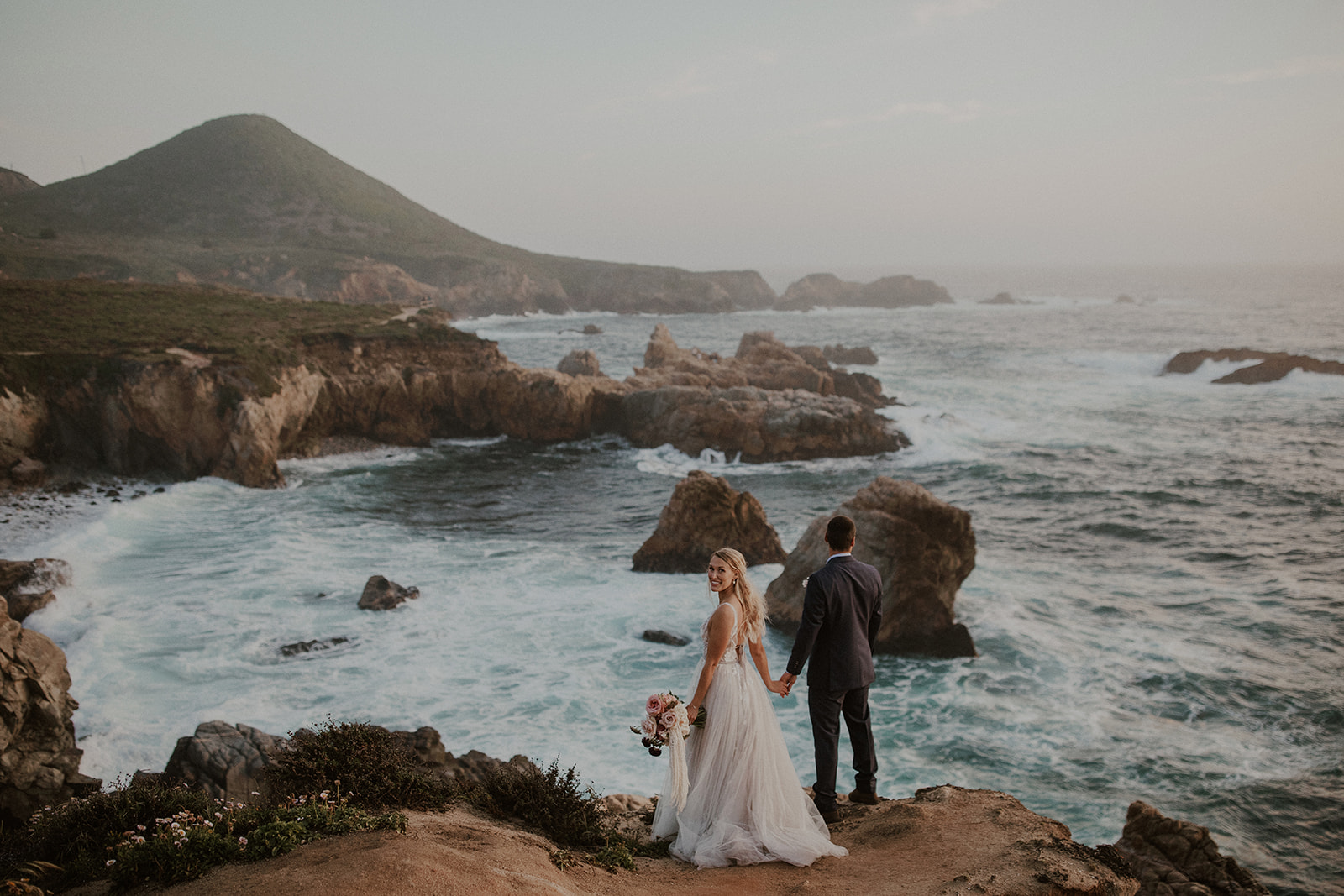 Bride and groom admiring the beauty of Big Sur