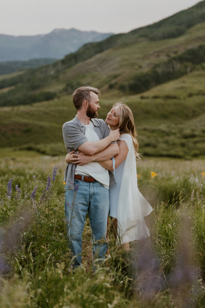 Couple holding each other during their Colorado engagement session in the mountains