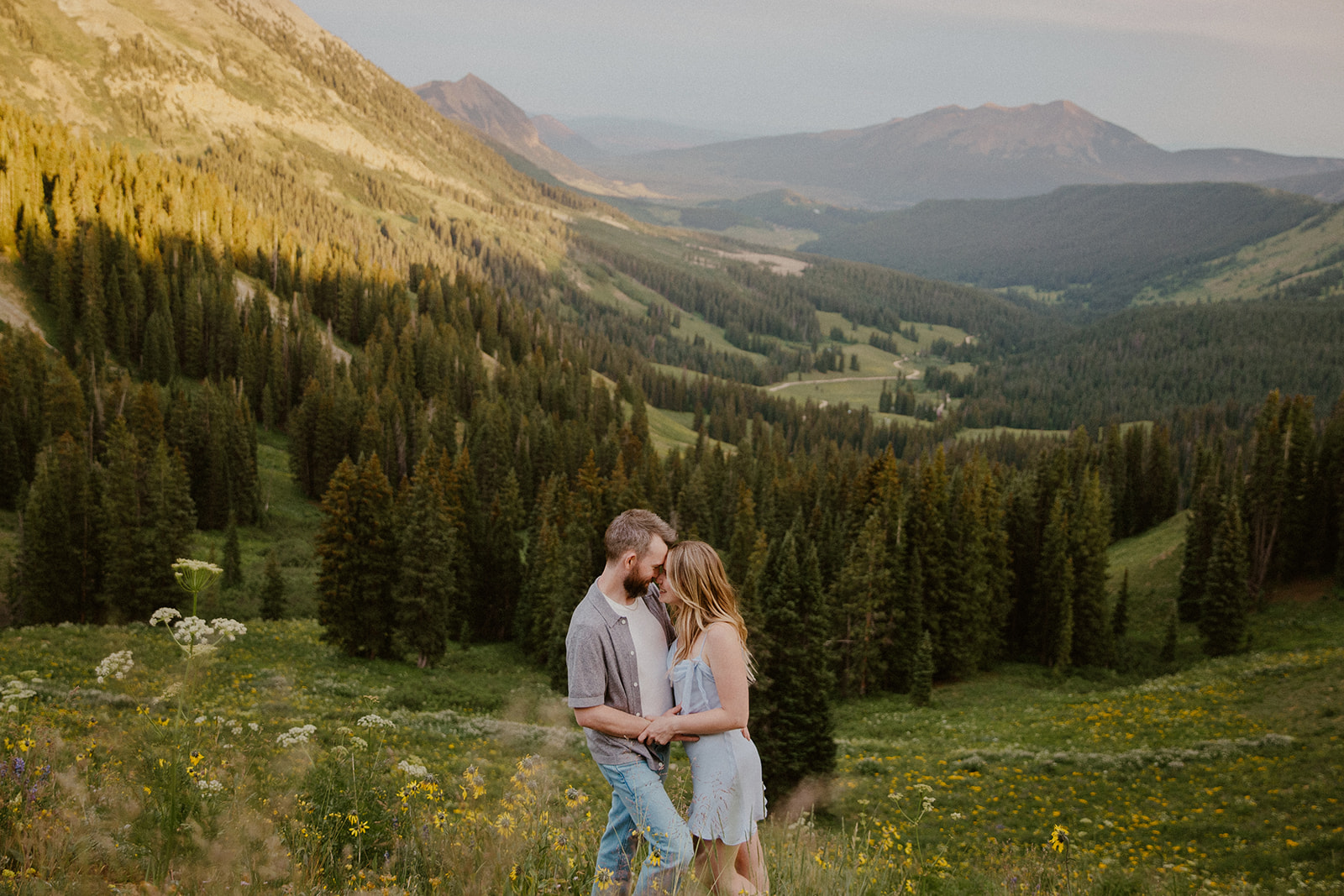 Couple leaning into each other during their romantic Crested Butte engagement photos