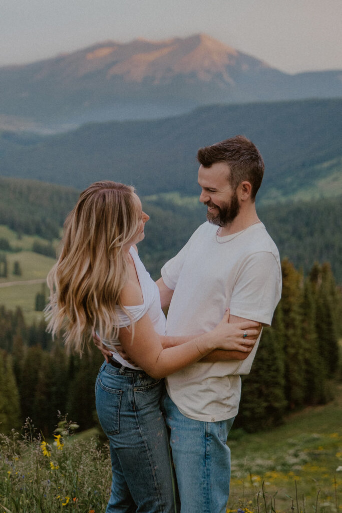 Couple smiling at laughing together in the mountains