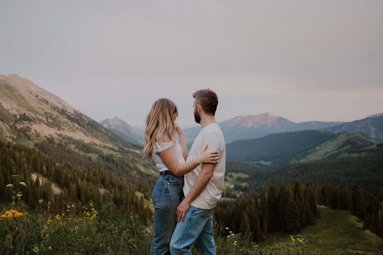 Couple admiring the mountains during their Crested Butte engagement photos