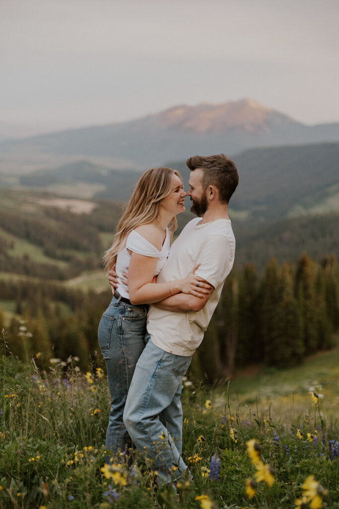 Couple touching noses and laughing during their Colorado mountain engagement