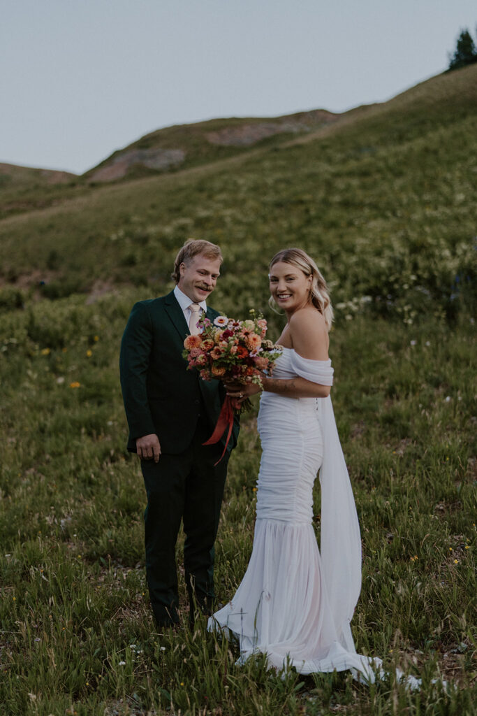 Bride and groom smiling at the camera after their first look