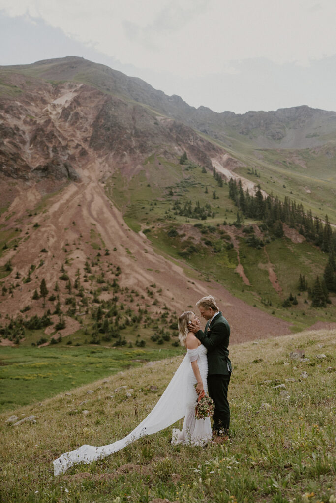 Bride and groom posing in the mountains
