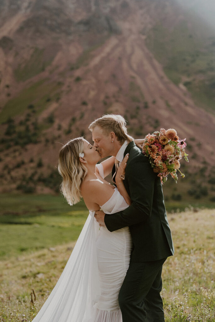Bride and groom kissing in the Colorado mountains