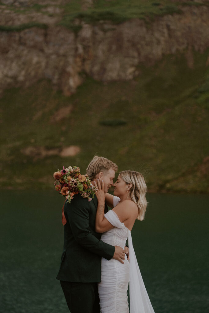 Bride and groom touching noses during their Colorado elopement