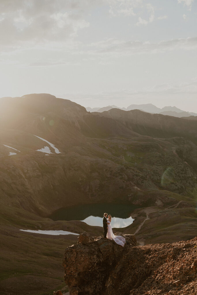 Bride and groom posing from afar in the San Juan Mountains for their elopement photos