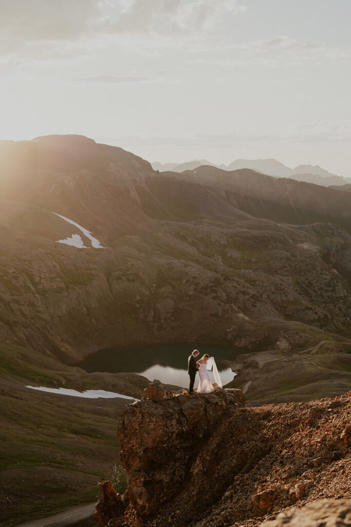 Bride and groom posing from afar in the San Juan Mountains for their elopement photos