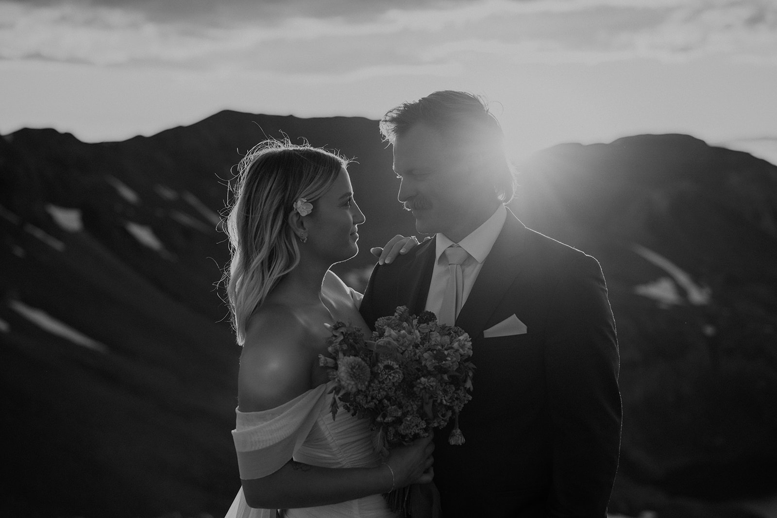 Black and white photo of a bride and groom in the San Juan mountains during their intimate elopement at golden hour