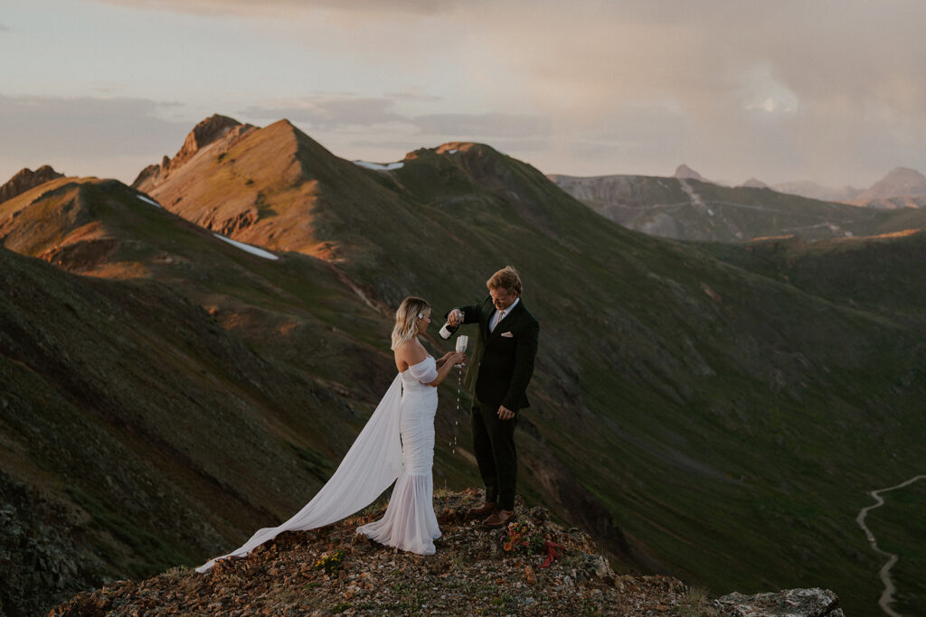 Bride and groom drinking champagne during their San Juan mountains elopement photos in Colorado
