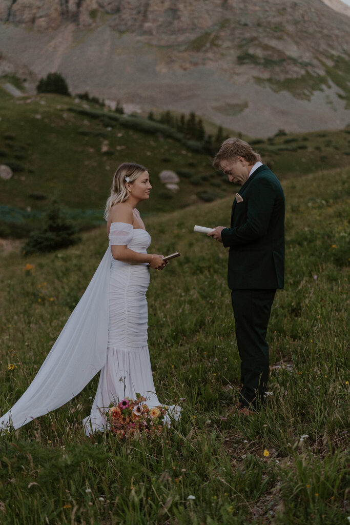 Bride and groom exchanging vows in the mountains