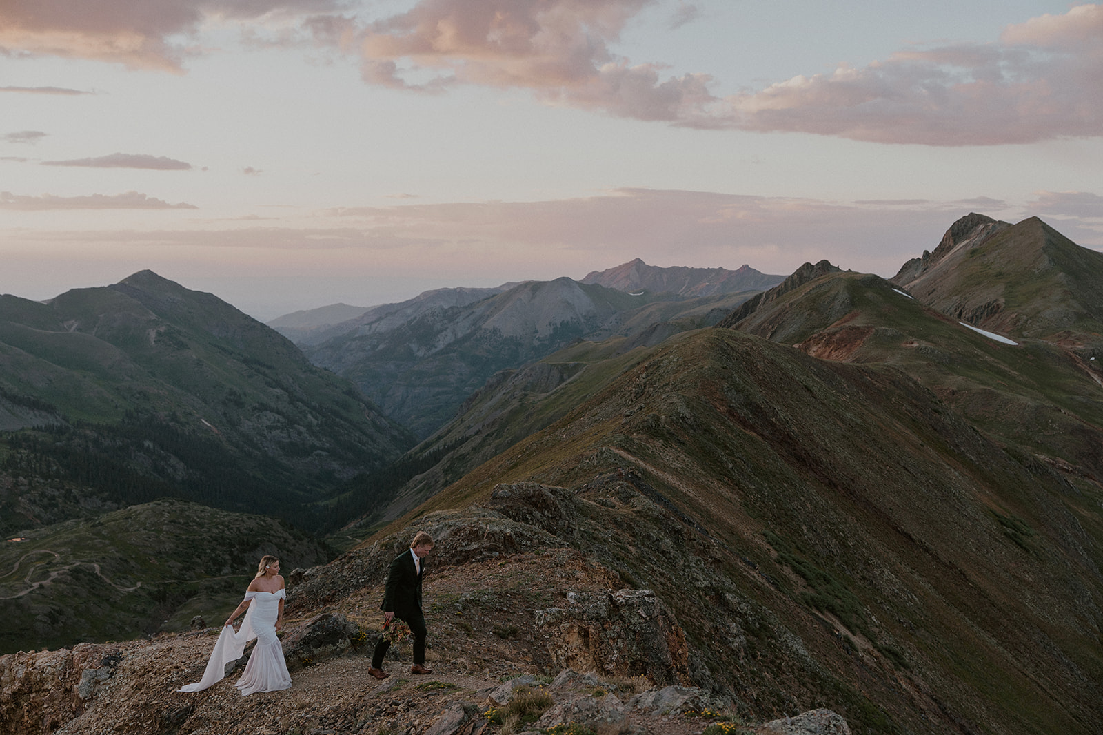 Bride and groom walking in the mountains during blue hour