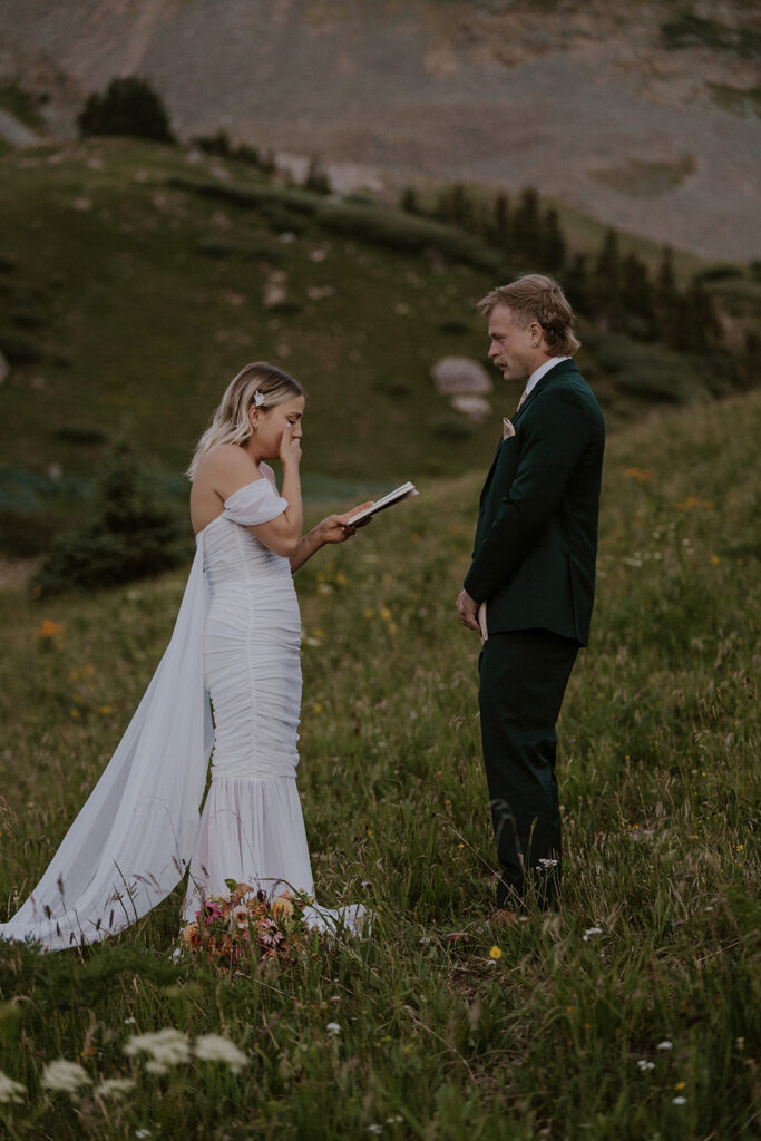 Bride and groom exchanging vows in the mountains