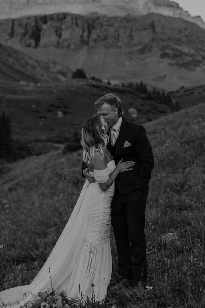 Black and white photo of a bride and groom kissing