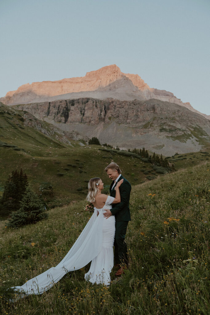 Bride and groom holding each other during their intimate mountain elopement in Colorado