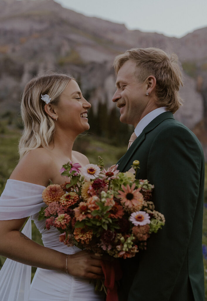 Bride and groom smiling at eachother during their San Juan mountains elopement photos