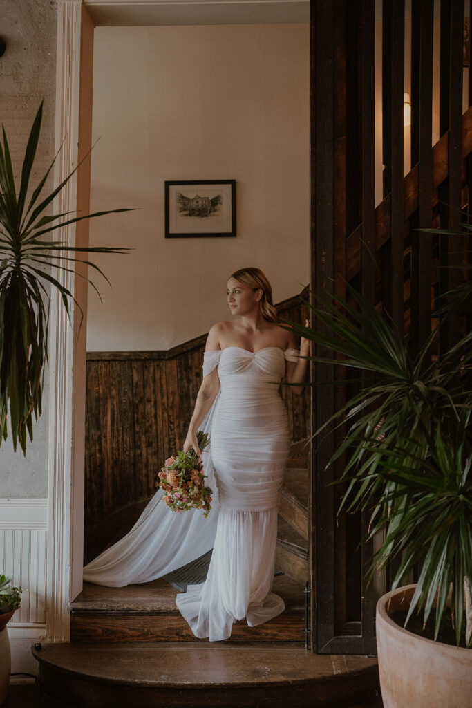 Bride posing on the staircase at Western Hotel in Ouray