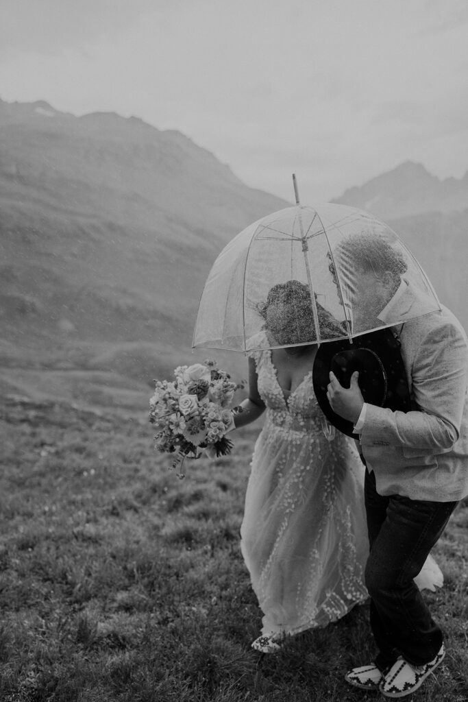 Rainy mountain elopement ceremony takes a turn