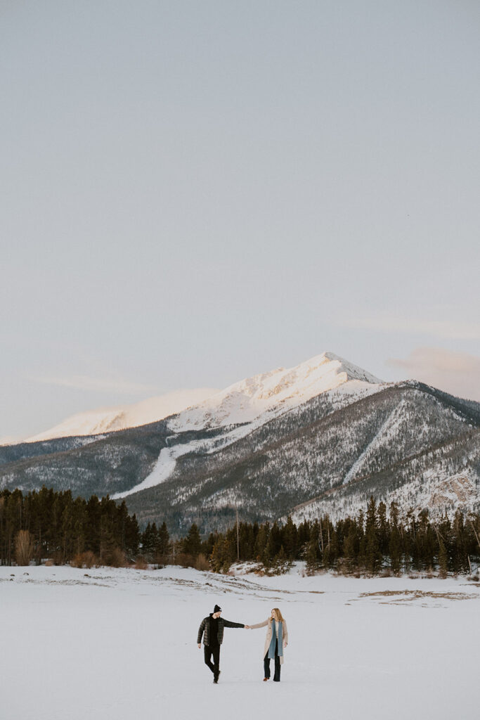 Snowy Colorado engagement photos during sunrise