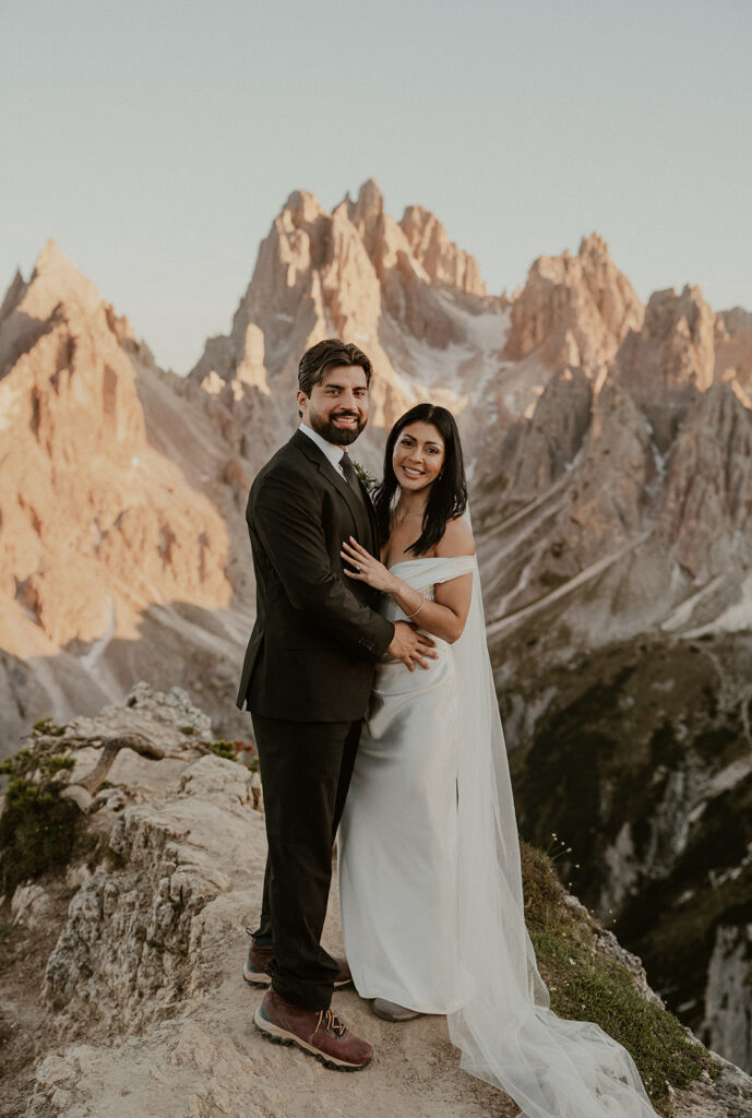 Couple stands with Tre Cime di Lavaredo in the backdrop