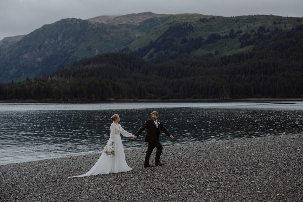 Alaska elopement photos by the ocean with a mountain backdrop