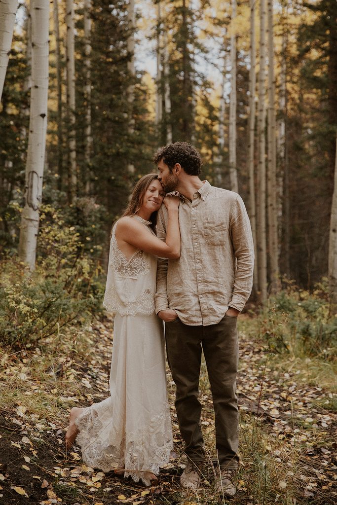 Bride and groom take wedding photos in the rain in the Aspens in Telluride