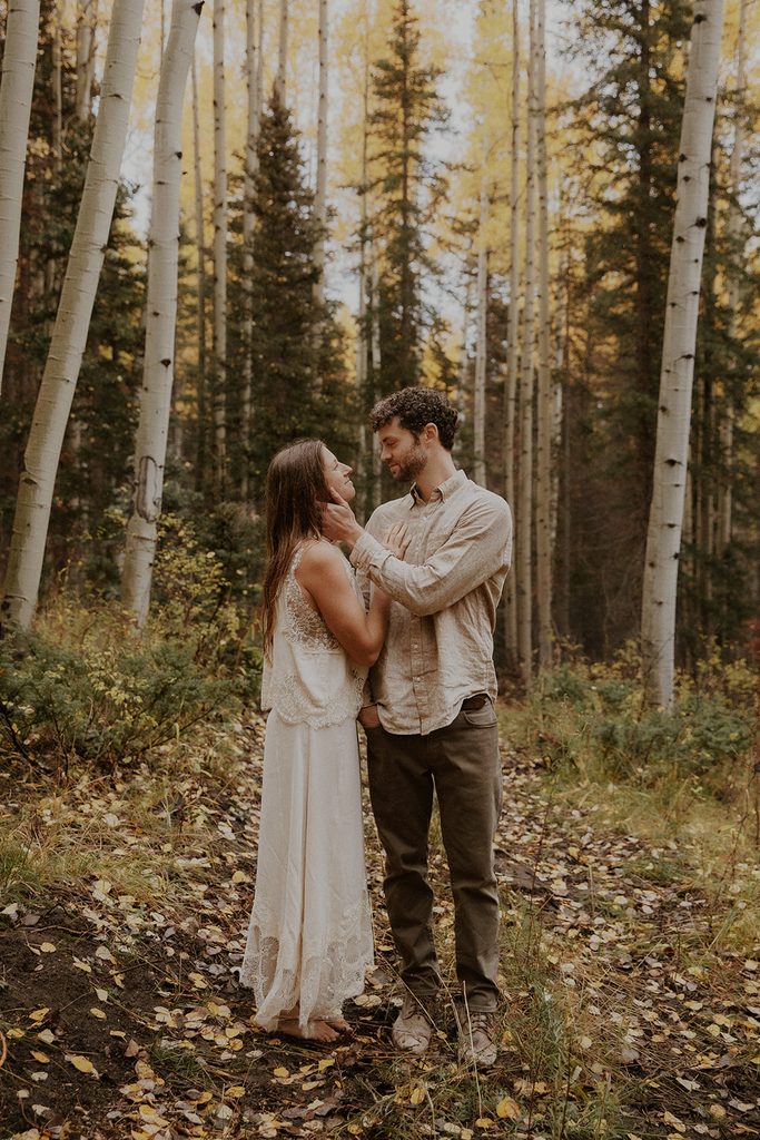 Bride and groom take wedding photos in the rain in the Aspens in Telluride