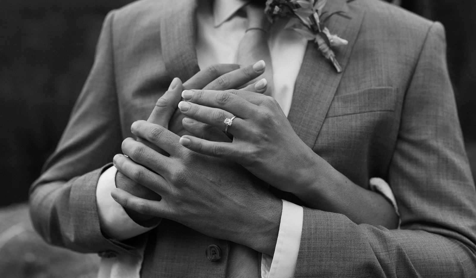 Details of a bride hugging her new husband from behind with hands on his chest The Lodge at Breckenridge Wedding